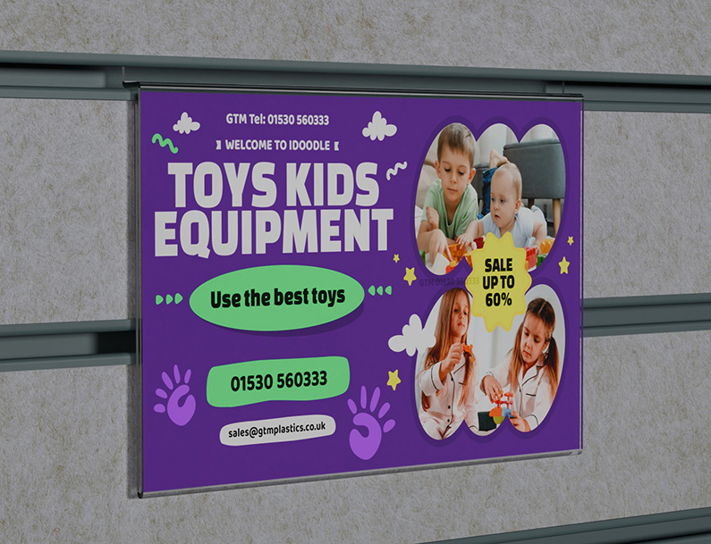 An acrylic slatwall landscape poster holder slotted into a white textured board which has grey inserts. The poster is advertising kids toys and equipment.