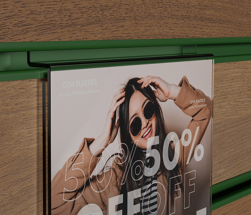 A zoomed in photo of an acrylic slatwall portrait poster holder that shows people wearing various fashionable clothes for sale. The shape of the slatwall section is clearly visible.