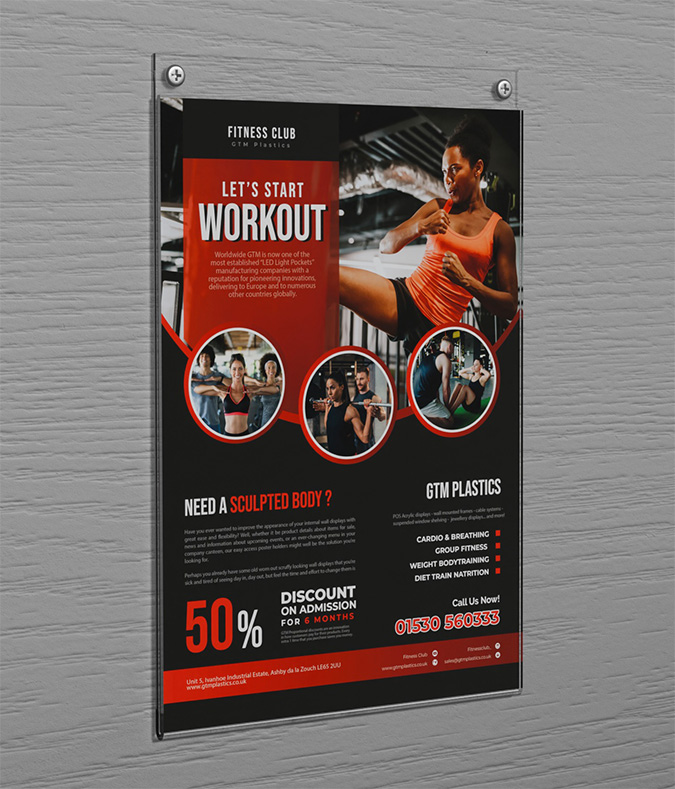 An acrylic wall mounted portrait poster holder attached to the wall with two screws. The poster is advertising a fitness club.