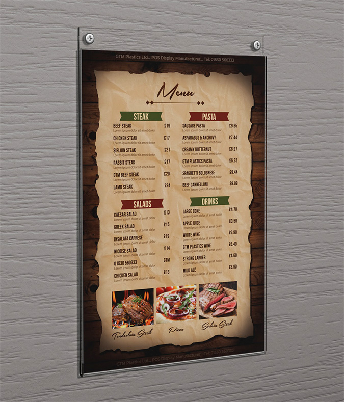 An acrylic wall mounted portrait poster holder attached to the wall with two screws. The poster is advertising steak, pasta and salad.