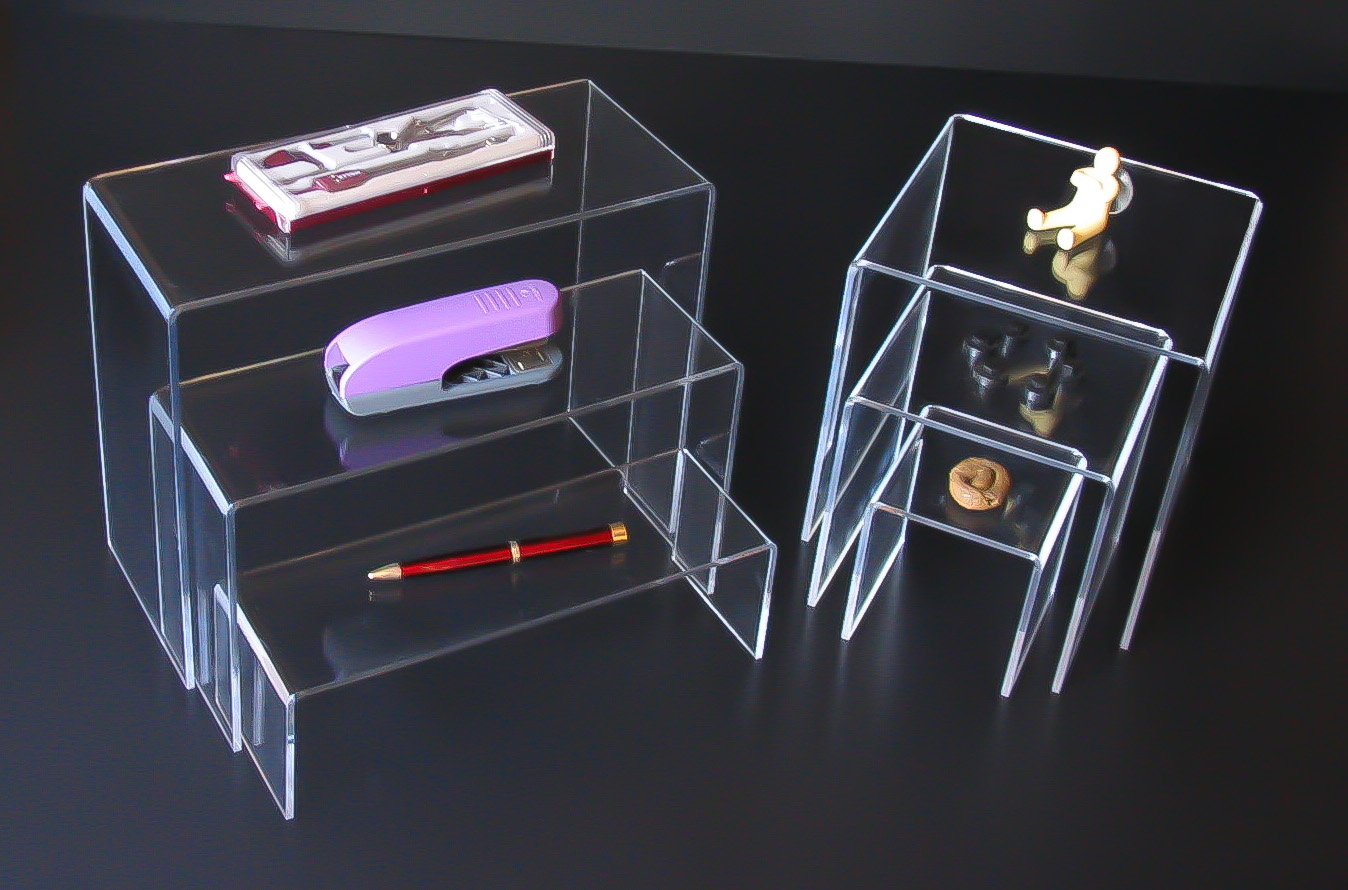 Nested acrylic display stands/bridges - two sets of three side by side, displaying stationary and small ornaments.